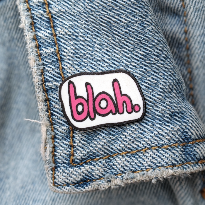 Blah pin worn on a jean jacket