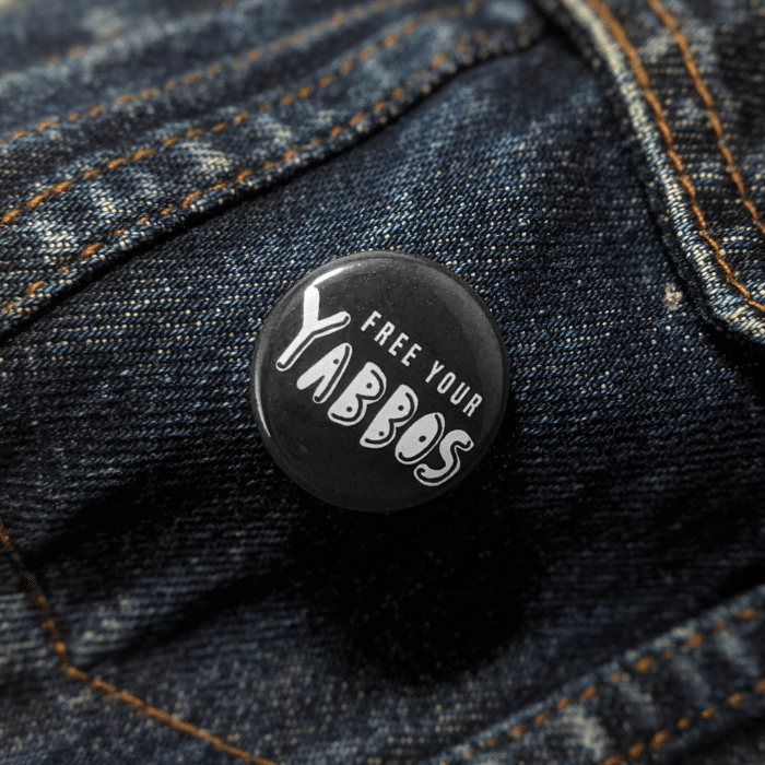 yabbos button worn on jean jacket